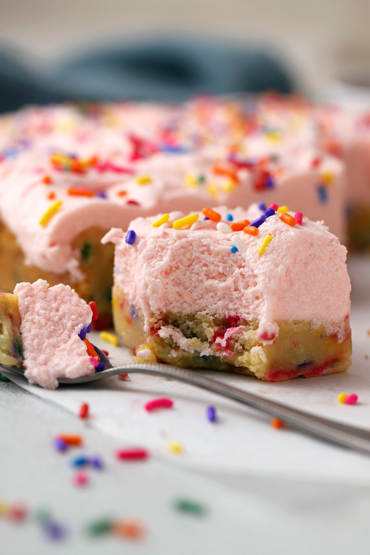 Soft, chewy sugar cookie bars topped with a light frosting for a sweet treat.